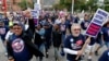 Members and family of unions walk in the annual Labor Day parade in Detroit, Monday, Sept. 5, 2011. (AP Photo/Paul Sancya)